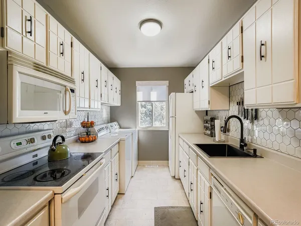 a kitchen with stainless steel appliances a sink a stove and cabinets