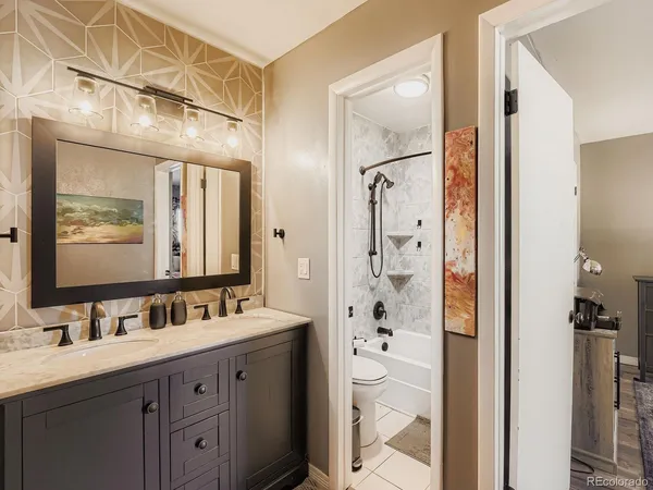 a bathroom with a double vanity sink mirror double and shower