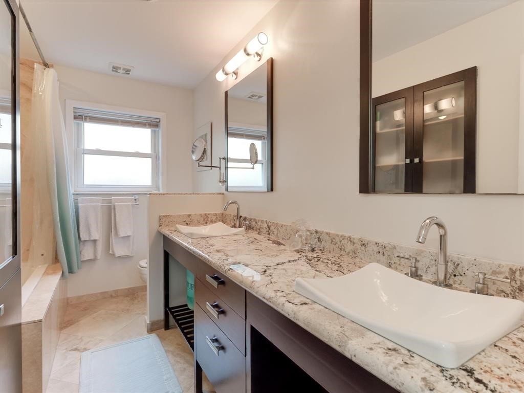 5630 Edith Street Houston, TX 77081 - Photo 22 of 30 Secondary bathroom with double sinks and granite counter tops.