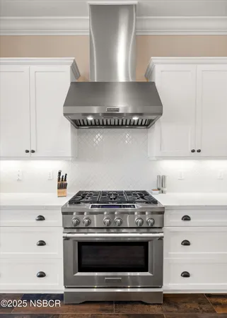 a stove top oven sitting inside of a kitchen