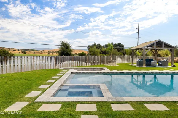 a view of a swimming pool with a lounge chairs