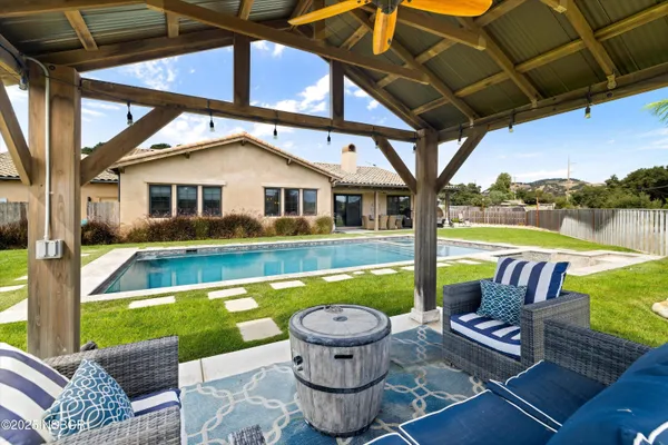a front view of house with yard outdoor seating and barbeque oven