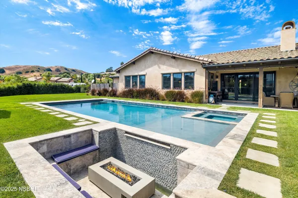 a view of an house with swimming pool and yard