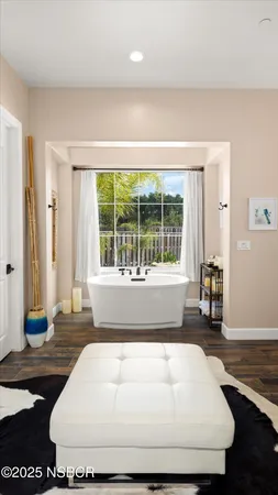 a bathroom with a tub sink toilet and a mirror