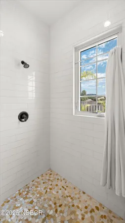 a bathroom with a sink a mirror and shower