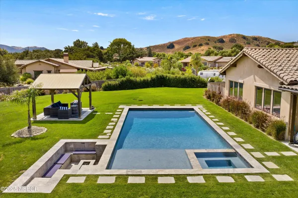 a view of an house with backyard space and balcony