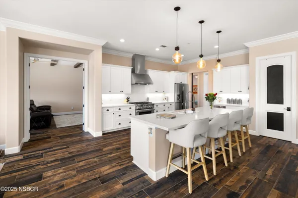 a large kitchen with a table and chairs
