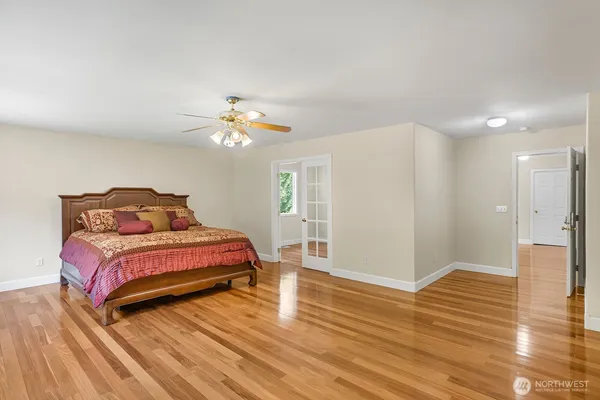 a bedroom with a bed and a chandelier