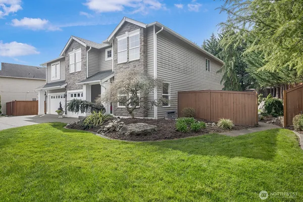 a view of a house with a yard and sitting area