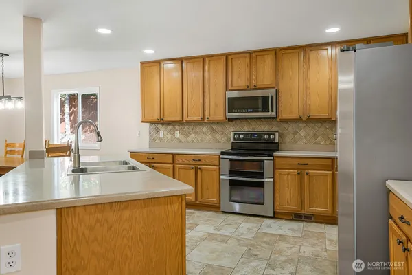 a kitchen with a stove a sink and a microwave