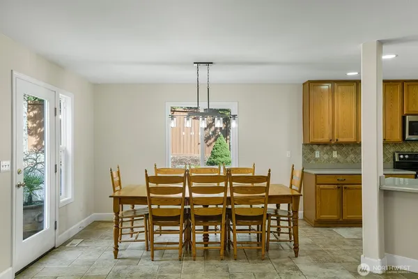 a dining room with furniture window and wooden floor