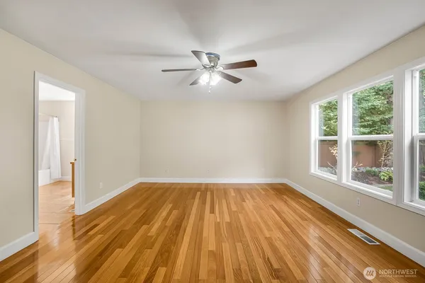 wooden floor in an empty room with a window
