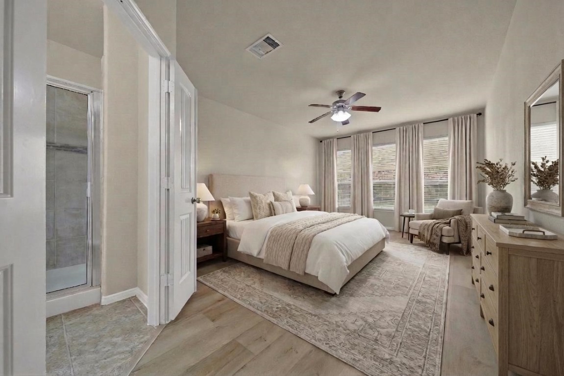 4419 Fenway Park Way Spring, TX 77389 - Photo 11 of 36 a spacious bedroom with a bed a chandelier and a window