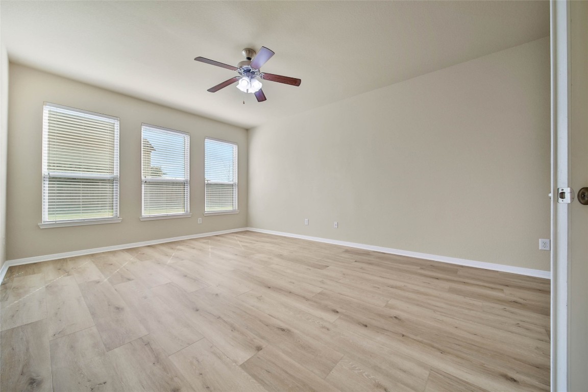 4419 Fenway Park Way Spring, TX 77389 - Photo 12 of 36 a view of an empty room with wooden floor and a window