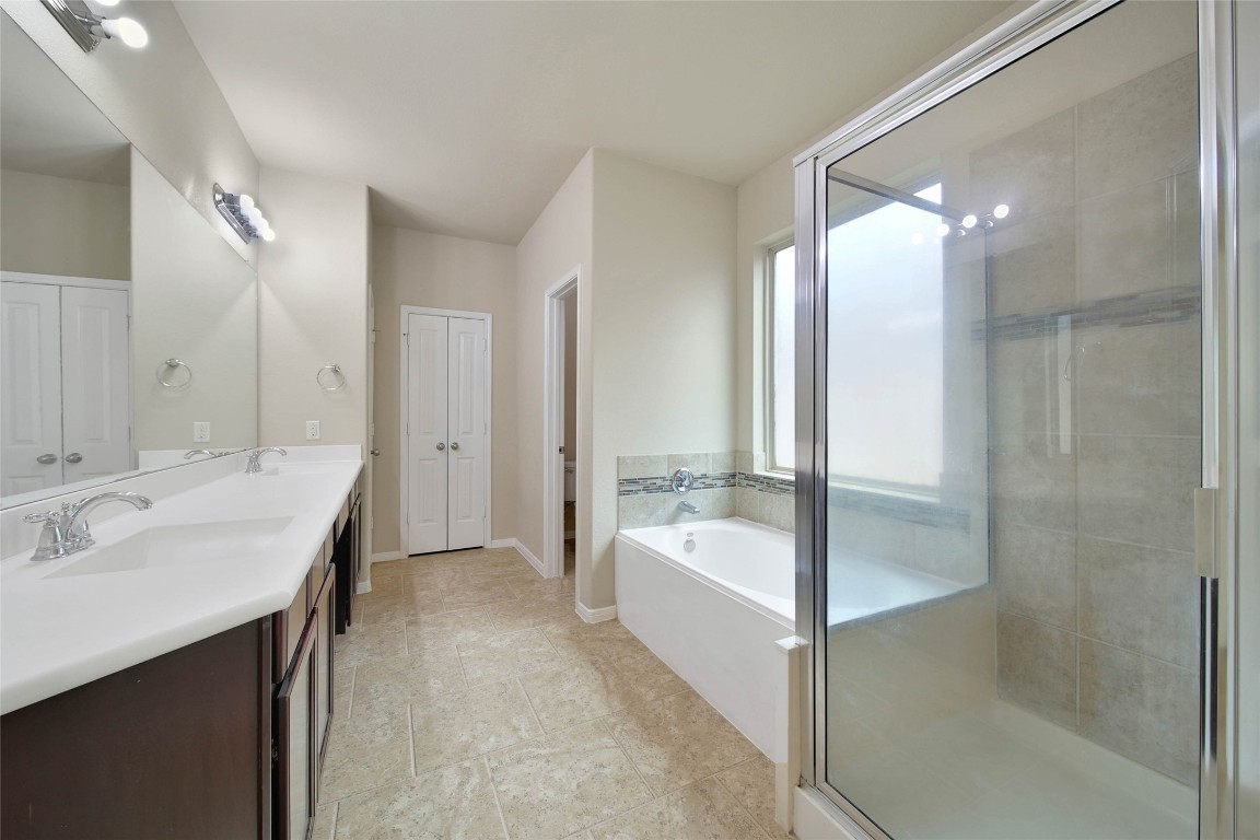 4419 Fenway Park Way Spring, TX 77389 - Photo 13 of 36 a bathroom with a bathtub shower sink and mirror