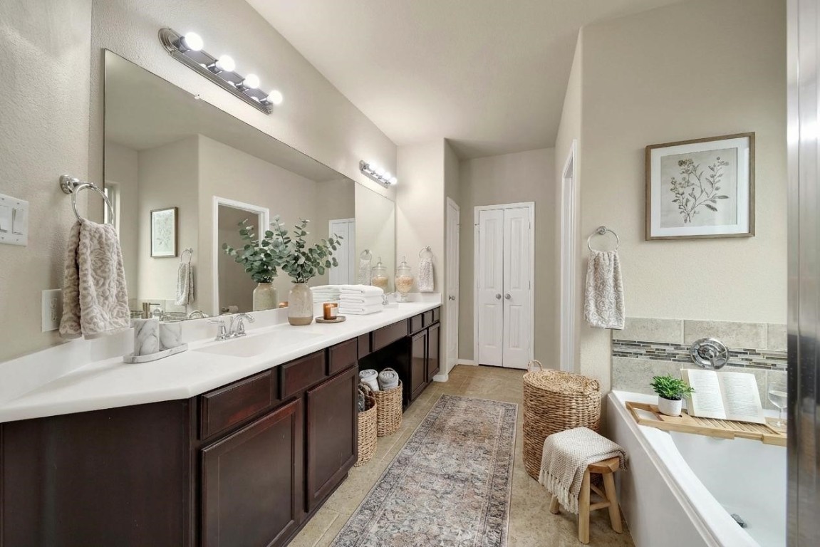 4419 Fenway Park Way Spring, TX 77389 - Photo 14 of 36 a spacious bathroom with a double vanity sink double mirror and a bathtub