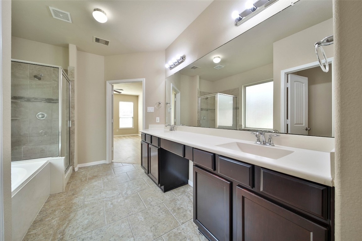 4419 Fenway Park Way Spring, TX 77389 - Photo 16 of 36 a bathroom with a sink double vanity granite tub shower and a mirror