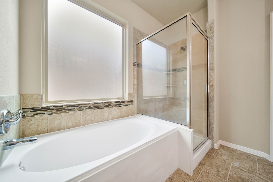 4419 Fenway Park Way Spring, TX 77389 - Photo 17 of 36 a bathroom with a bathtub and a shower