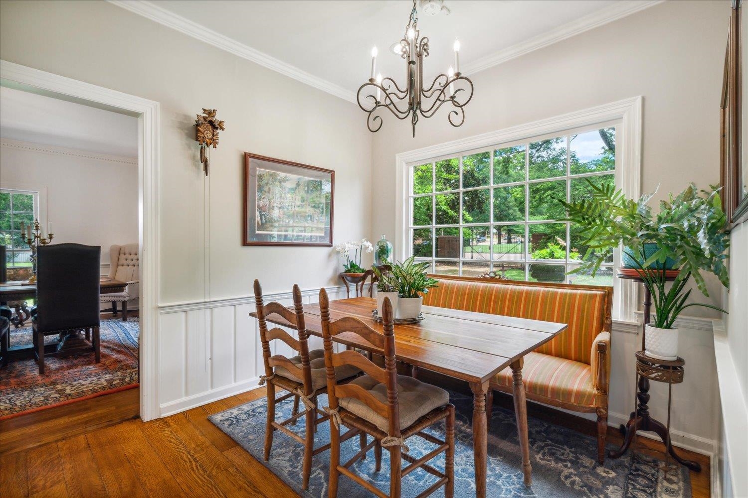 4585 Walnut Grove Road Memphis, TN 38117 - Photo 12 of 36 a dining room with furniture a large window and wooden floor