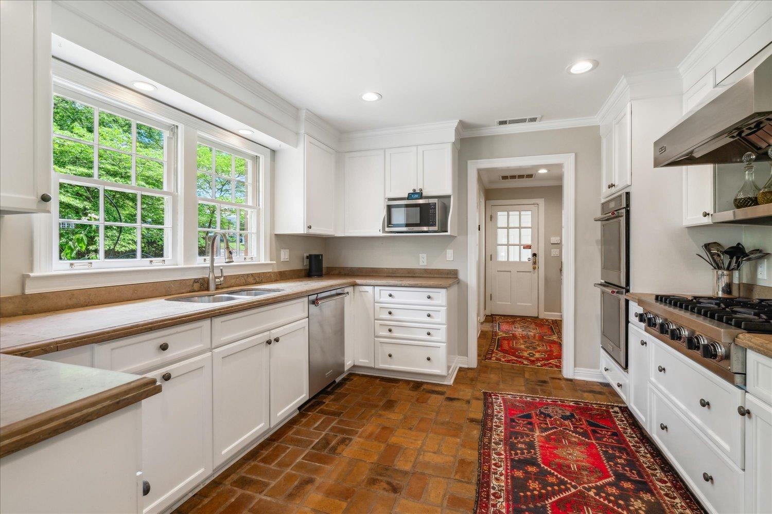 4585 Walnut Grove Road Memphis, TN 38117 - Photo 14 of 36 a kitchen with stainless steel appliances granite countertop a stove a sink and a refrigerator
