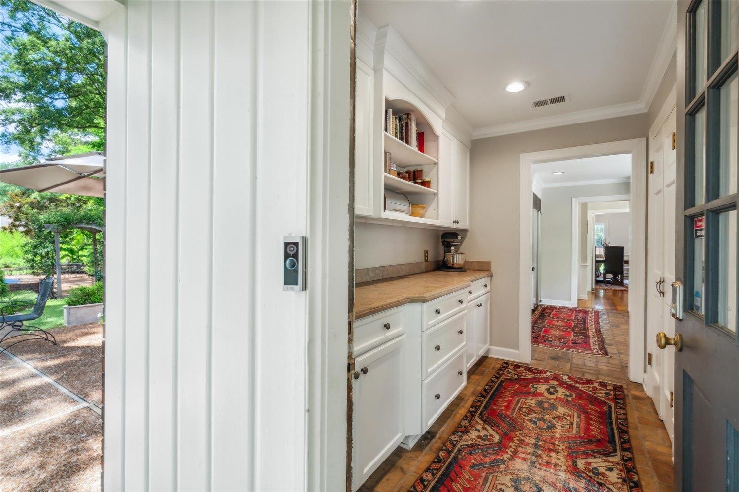 4585 Walnut Grove Road Memphis, TN 38117 - Photo 17 of 36 a hall with kitchen island white cabinets and a window