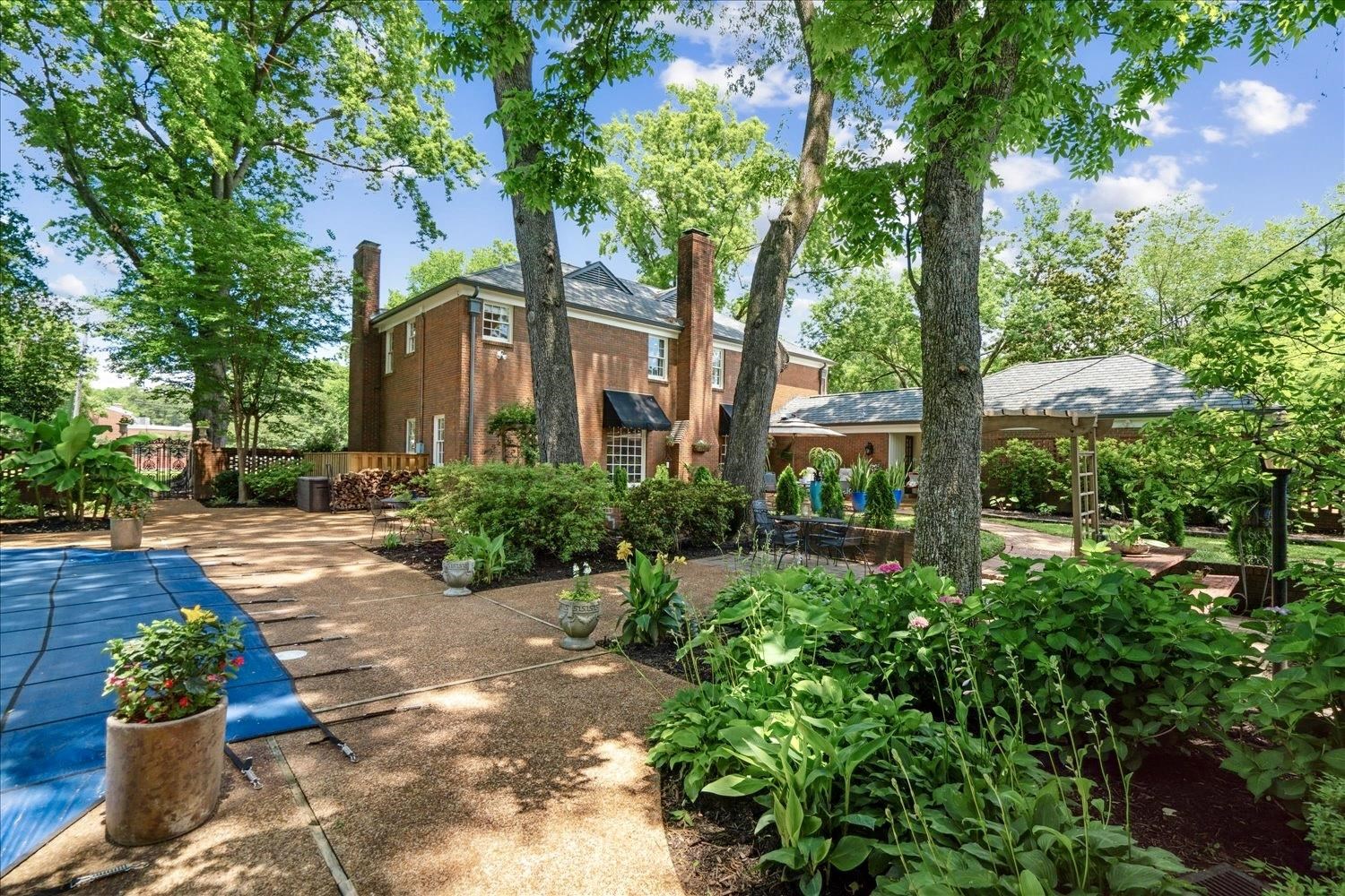 4585 Walnut Grove Road Memphis, TN 38117 - Photo 31 of 36 a front view of a house with garden