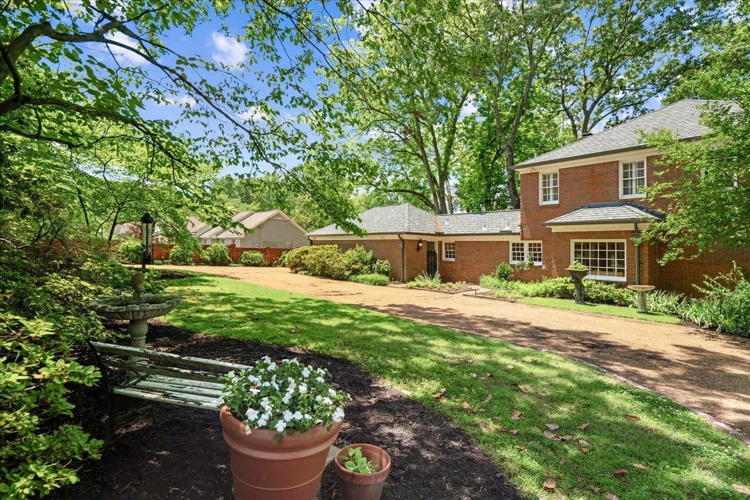 4585 Walnut Grove Road Memphis, TN 38117 - Photo 34 of 36 a front view of a house with a garden