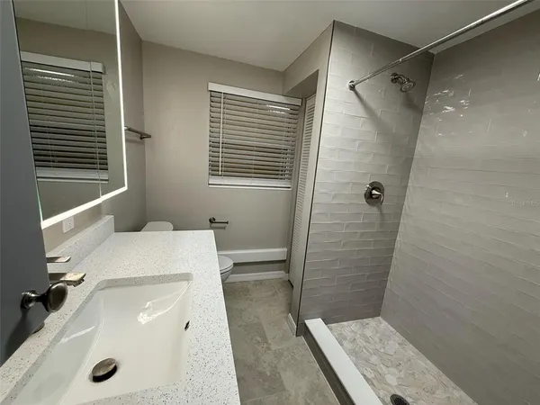 a bedroom with a bed and a mirror