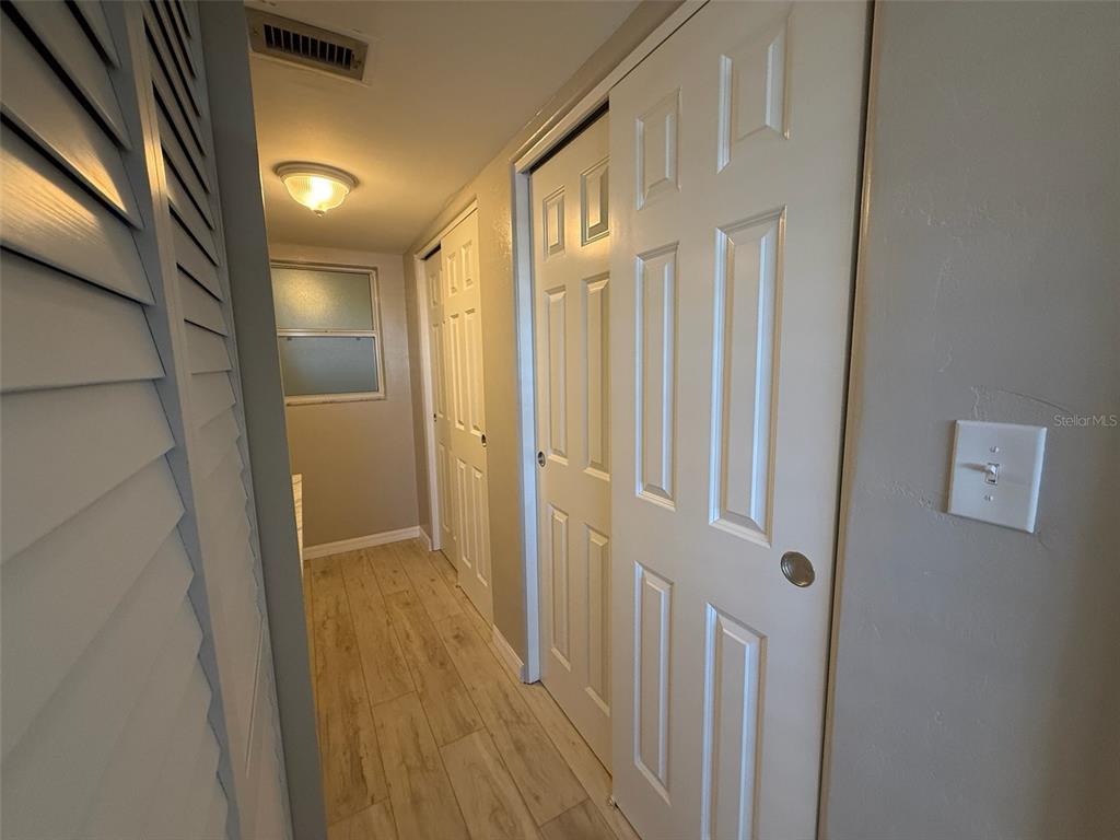 175 55th Avenue, Unit 109 St. Pete Beach, FL 33706 - Photo 21 of 27 a view of a hallway with wooden floor