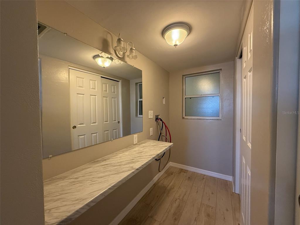 175 55th Avenue, Unit 109 St. Pete Beach, FL 33706 - Photo 22 of 27 a bedroom with a bed and a mirror