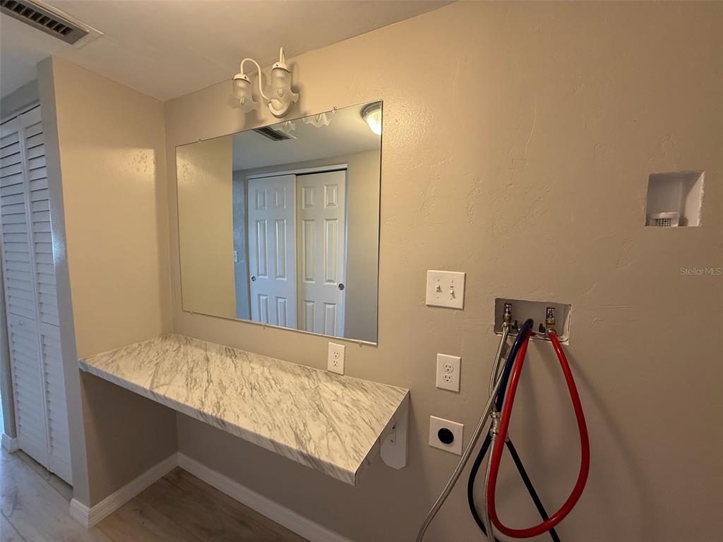175 55th Avenue, Unit 109 St. Pete Beach, FL 33706 - Photo 23 of 27 a bathroom with a sink and mirror