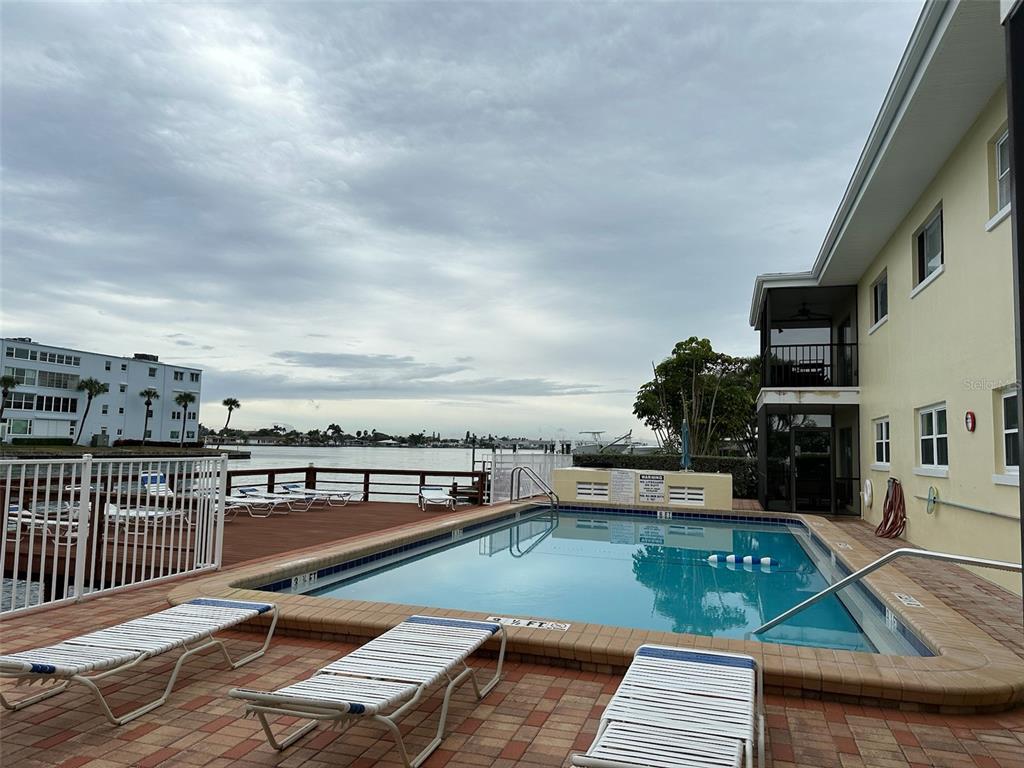 175 55th Avenue, Unit 109 St. Pete Beach, FL 33706 - Photo 25 of 27 a view of a swimming pool with seating space