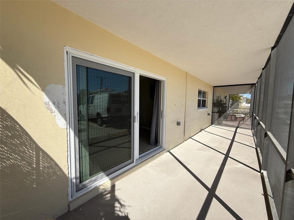 175 55th Avenue, Unit 109 St. Pete Beach, FL 33706 - Photo 7 of 27 a view of a hallway with a flat screen tv