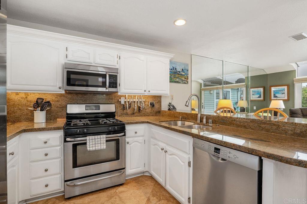 7010 Lantana Terrace Carlsbad, CA 92011 - Photo 14 of 45 a kitchen with appliances a sink and cabinets