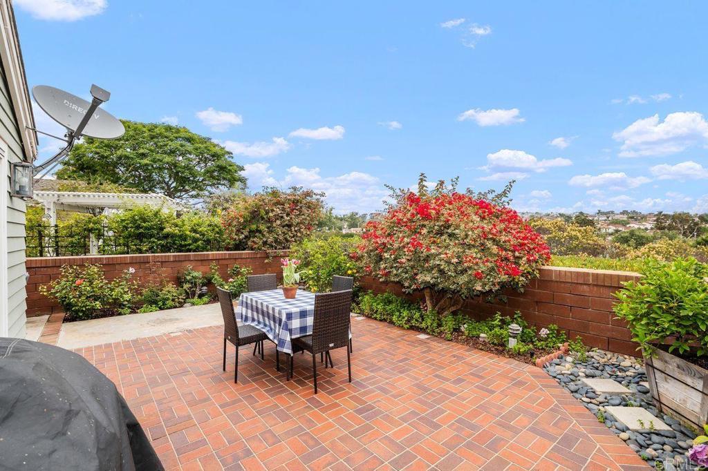 7010 Lantana Terrace Carlsbad, CA 92011 - Photo 19 of 45 a view of a tables and chairs in back yard of the house