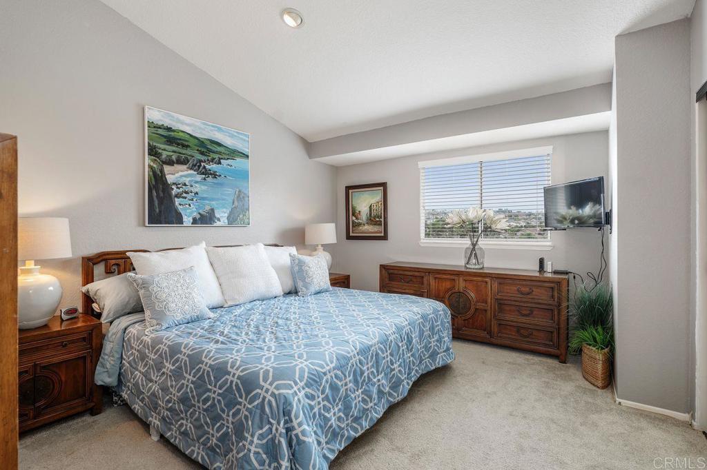 7010 Lantana Terrace Carlsbad, CA 92011 - Photo 23 of 45 a bedroom with a large bed and a dresser
