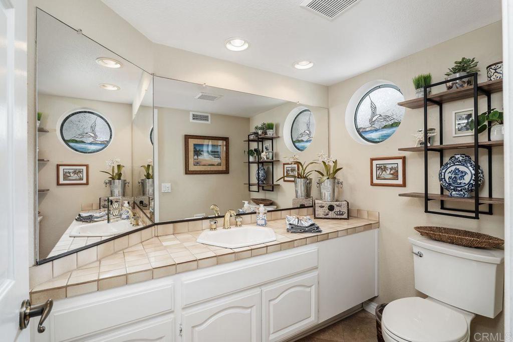 7010 Lantana Terrace Carlsbad, CA 92011 - Photo 33 of 45 a bathroom with a two sink and a mirror