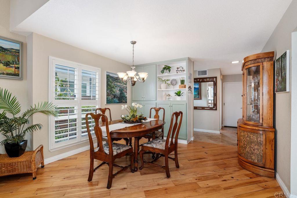 7010 Lantana Terrace Carlsbad, CA 92011 - Photo 8 of 45 a view of a dining room with furniture window and wooden floor