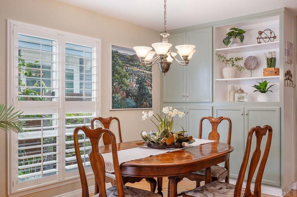 7010 Lantana Terrace Carlsbad, CA 92011 - Photo 9 of 45 a view of a dining room with furniture a chandelier and large windows
