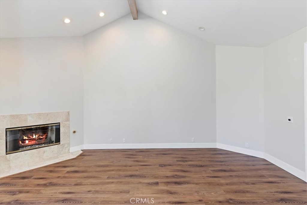 1507 Weston Way Riverside, CA 92506 - Photo 12 of 55 a view of an empty room with wooden floor and a fireplace