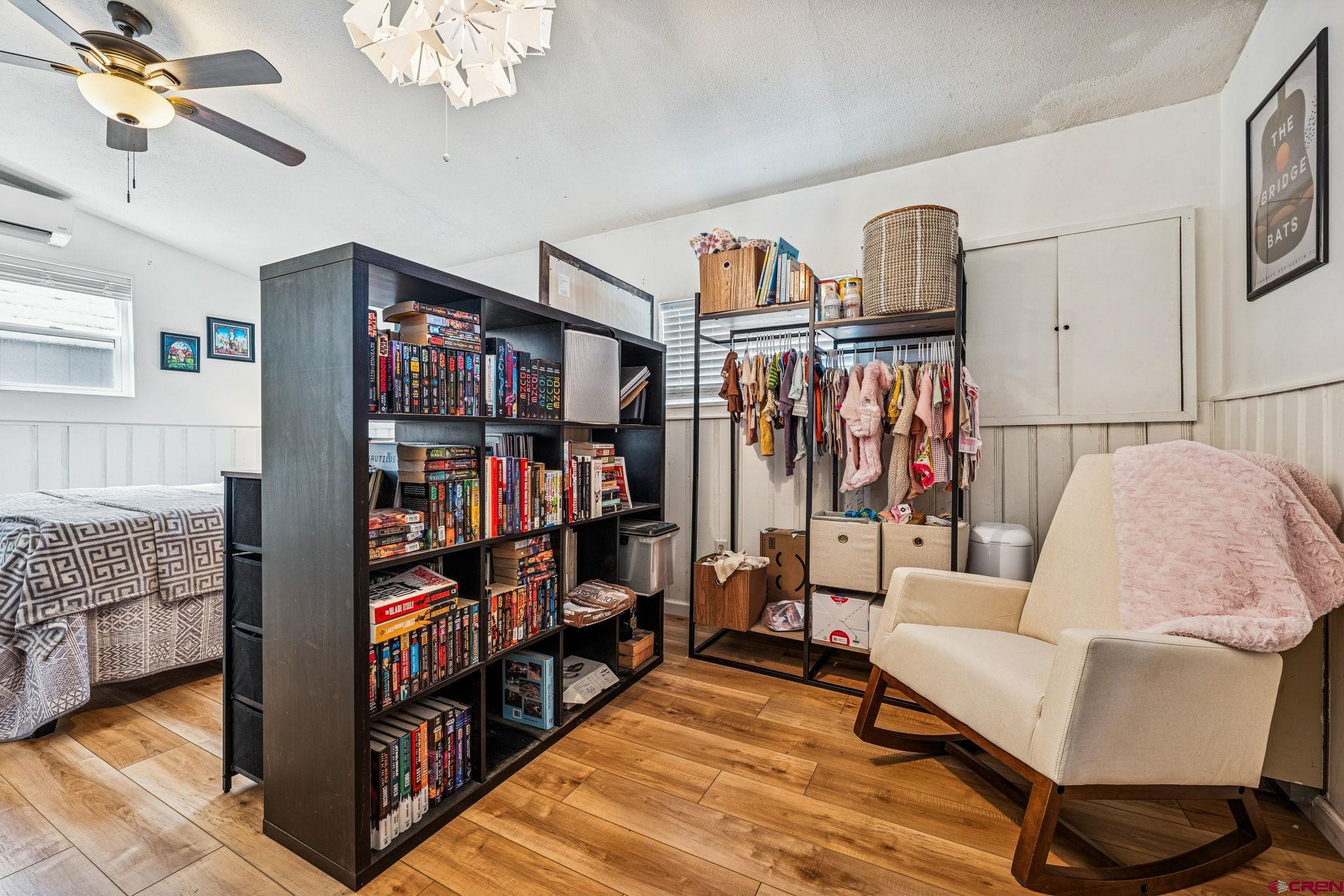476 East 5th Street Durango, CO 81301 - Photo 17 of 40 a living room with lots of furniture and a book shelf