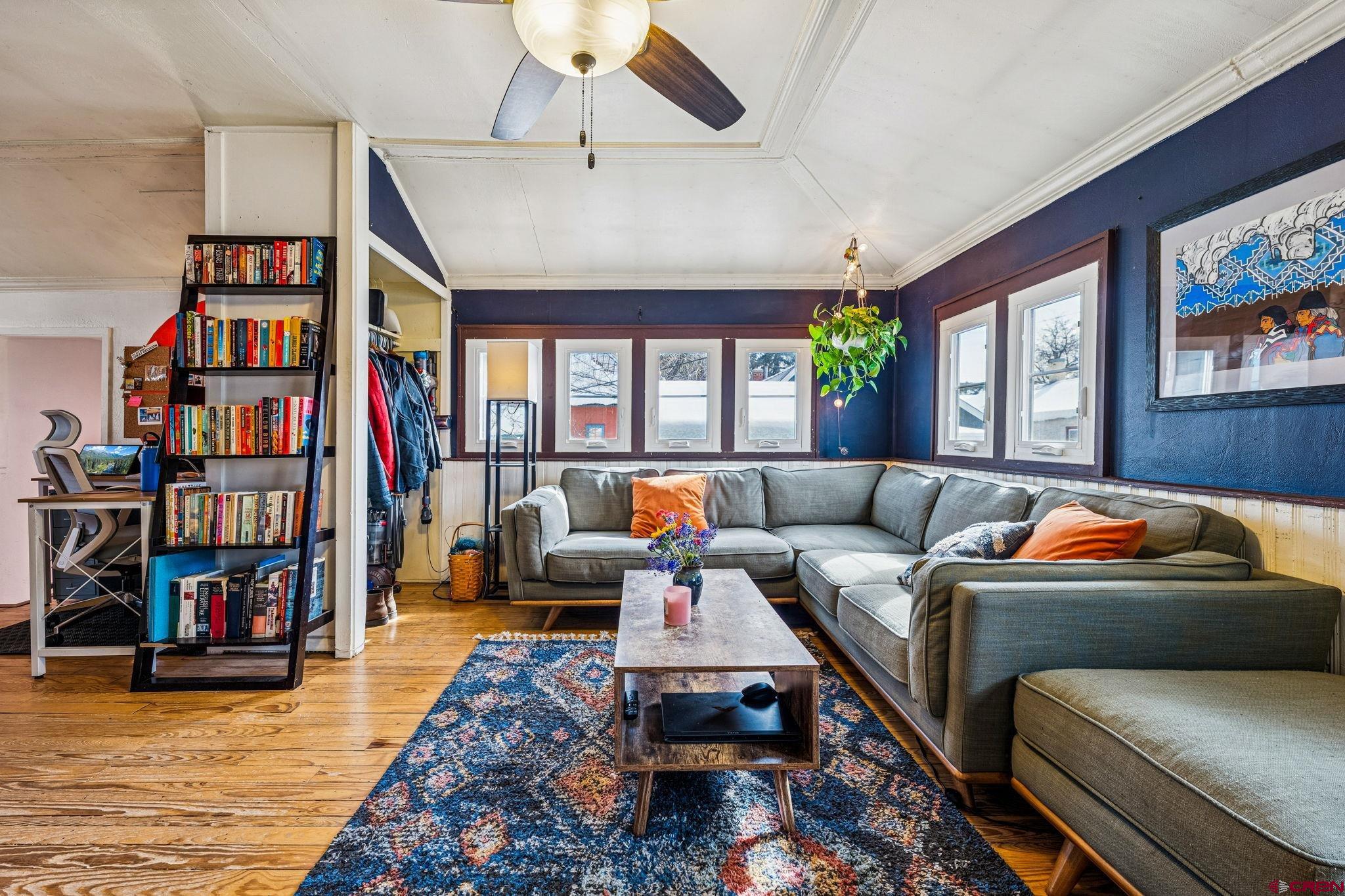 476 East 5th Street Durango, CO 81301 - Photo 6 of 40 a living room with lots of furniture and a book shelf