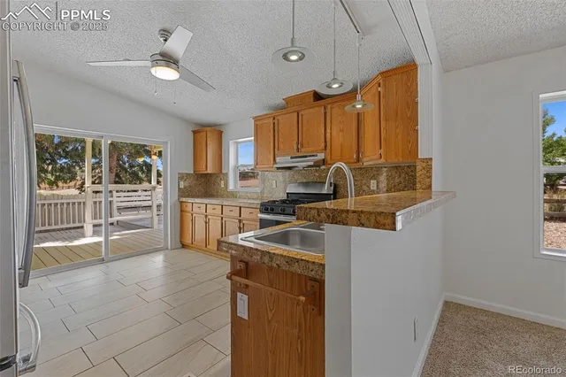 a kitchen with sink cabinets and window