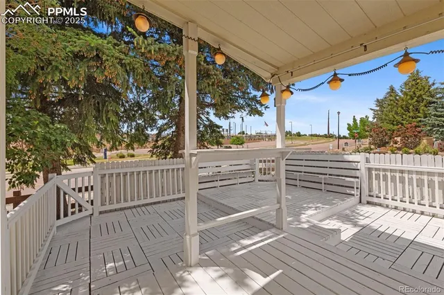 a view of a porch with wooden floor and bench