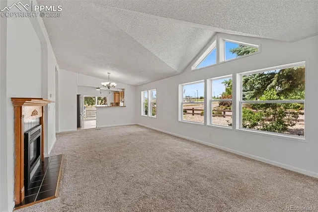 a view of livingroom with furniture and a fireplace