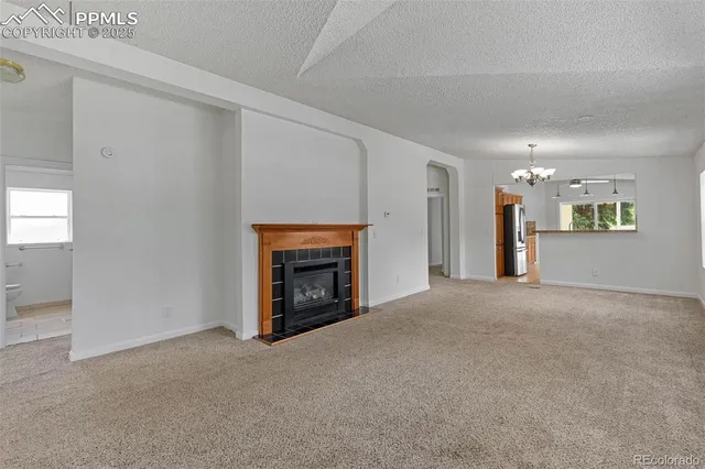 a view of empty room with a fireplace