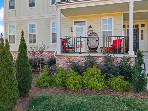 a view of a house with a small yard and flower plants