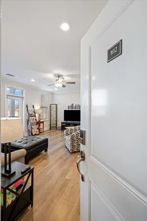 a living room with furniture or wooden floor and a flat screen tv