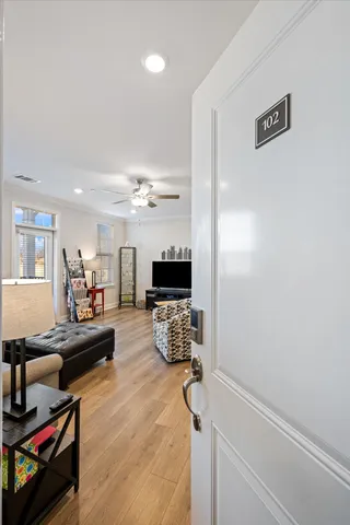 a living room with furniture or wooden floor and a flat screen tv