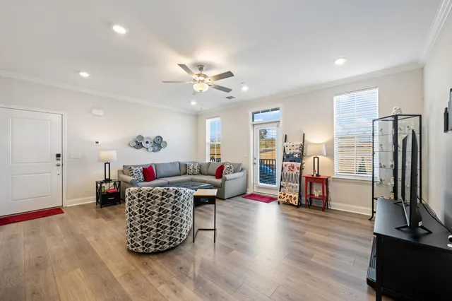 a living room with furniture and kitchen view